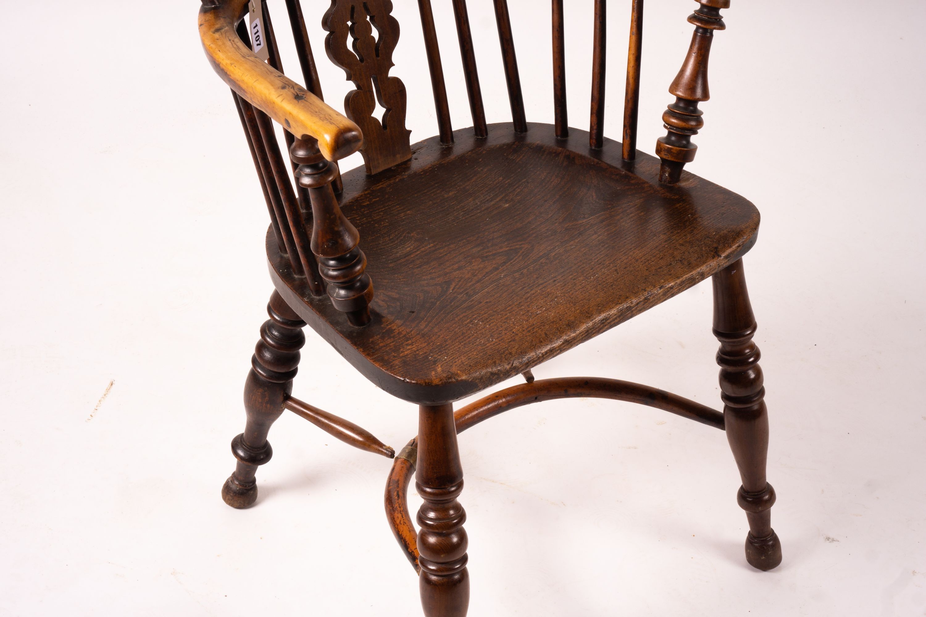 A 19th century yew and elm Yorkshire area Windsor elbow chair with crinoline stretcher, width 60cm, depth 45cm, height 93cm